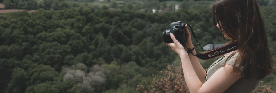 photo Mallaurie Photographe avec son appareil photo devant un paysage de nature